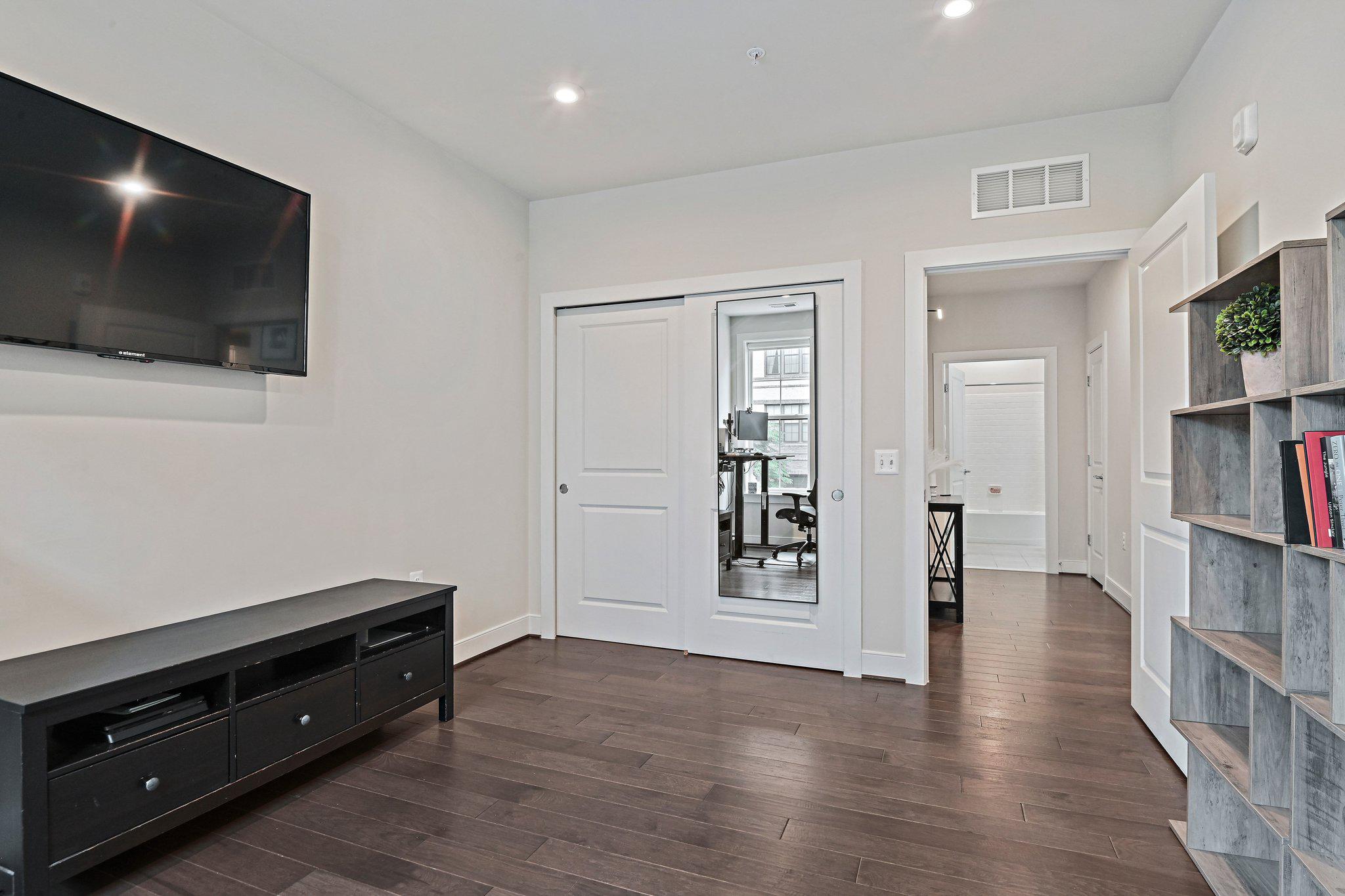 2320 Field Point Road, Unit 4102 Herndon, VA 20171 - Photo 23 of 39 a view of a livingroom with wooden floor and a flat screen tv