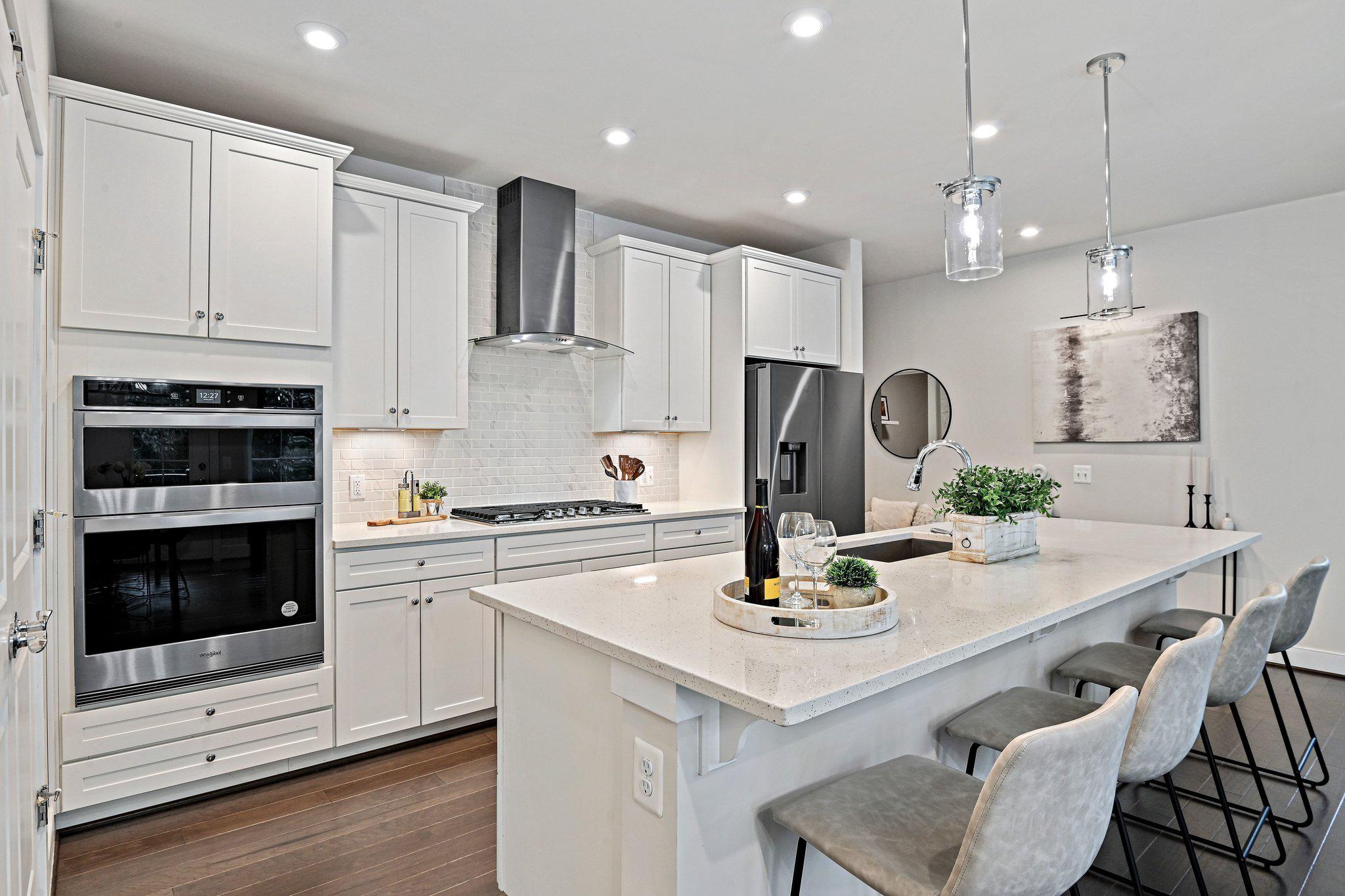 2320 Field Point Road, Unit 4102 Herndon, VA 20171 - Photo 7 of 39 a kitchen that has a lot of white cabinets and stainless steel appliances