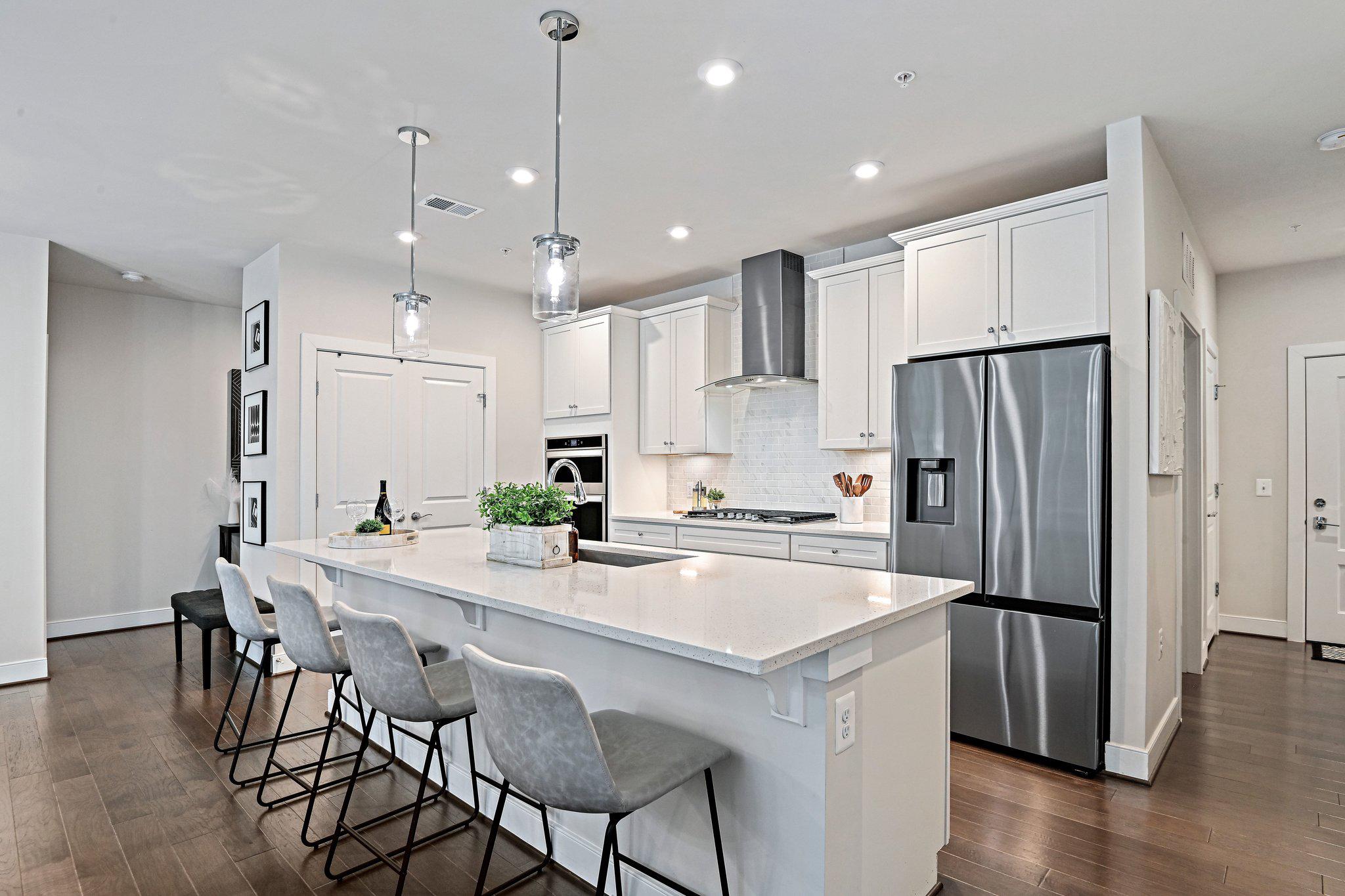 2320 Field Point Road, Unit 4102 Herndon, VA 20171 - Photo 8 of 39 a kitchen with stainless steel appliances granite countertop a refrigerator a sink a stove a dining table and chairs
