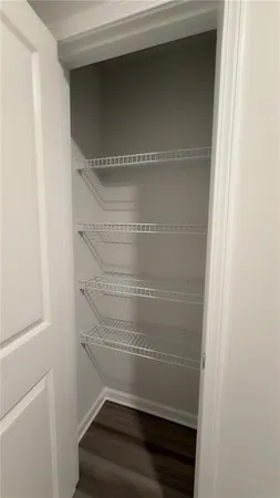 a view of walk in closet with empty racks