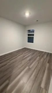 a view of an empty room and a window