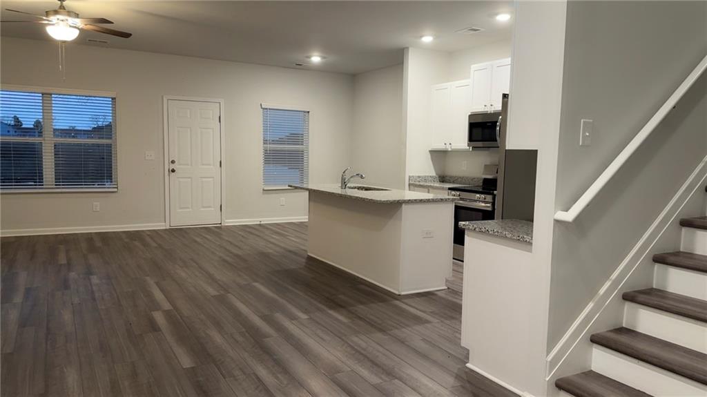 122 Brexley Drive Calhoun, GA 30701 - Photo 3 of 28 a view of a kitchen with wooden floor and electronic appliances