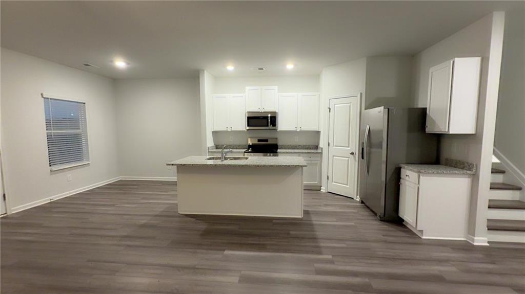 122 Brexley Drive Calhoun, GA 30701 - Photo 4 of 28 a kitchen with stainless steel appliances a refrigerator stove microwave and cabinets