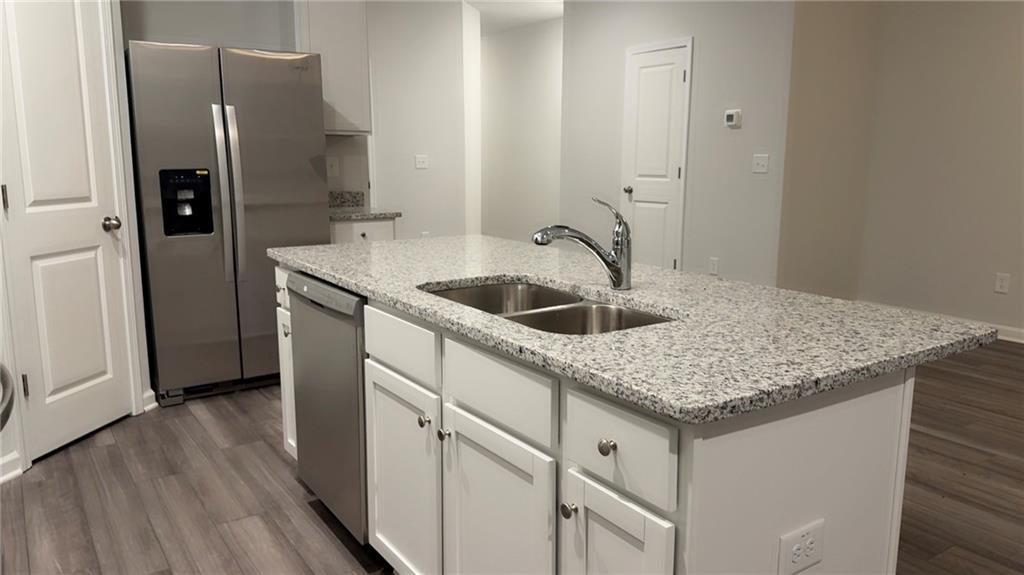 122 Brexley Drive Calhoun, GA 30701 - Photo 7 of 28 a kitchen with stainless steel appliances granite countertop a sink and refrigerator