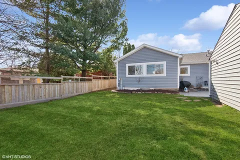 a front view of house with yard and green space