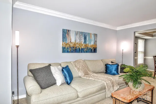 a living room with furniture and a potted plant