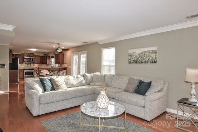 a living room with furniture and a dining table
