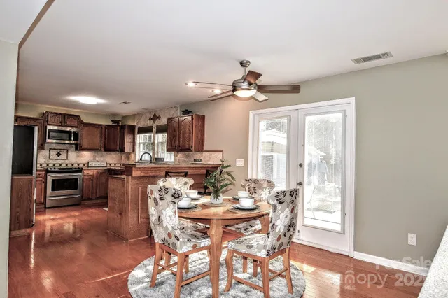 a view of a dining room with furniture and a kitchen