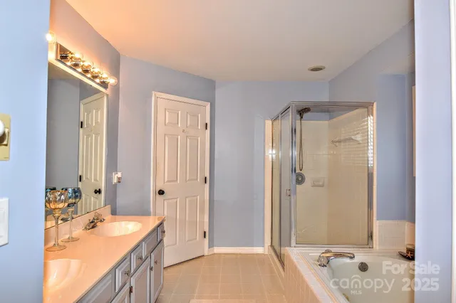 a bathroom with a tub sink and mirror