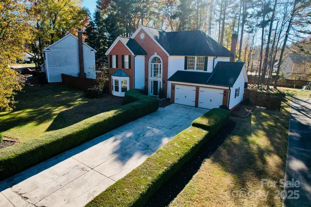 a view of house with yard and green space