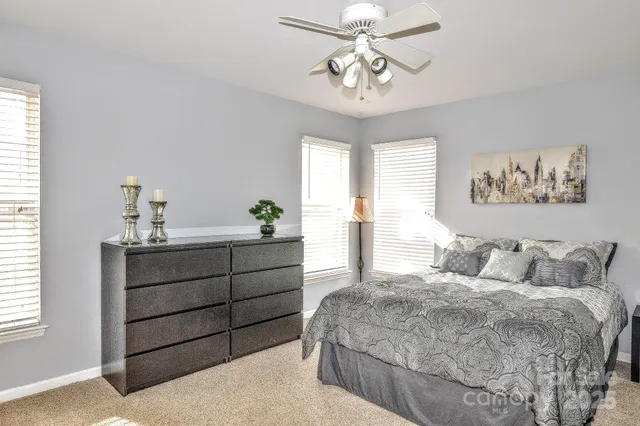 a spacious bedroom with a bed and a chandelier