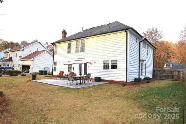 a view of a house with backyard and sitting area
