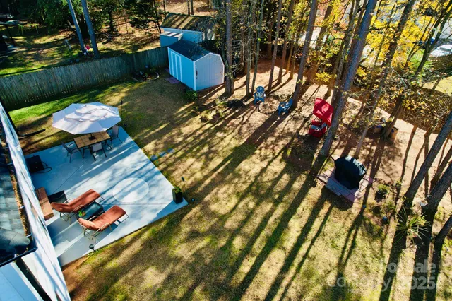 a view of yard from deck with patio
