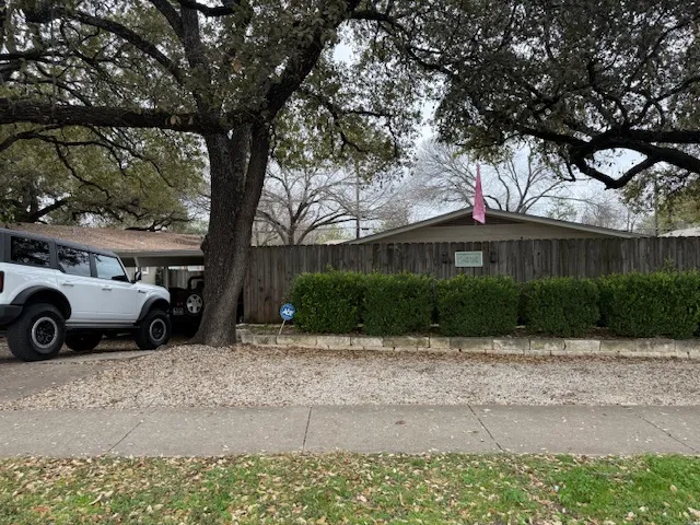 a view of a car parked in front of a house