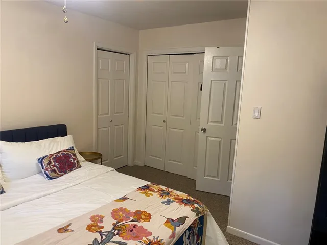 a bedroom with a bed and a table