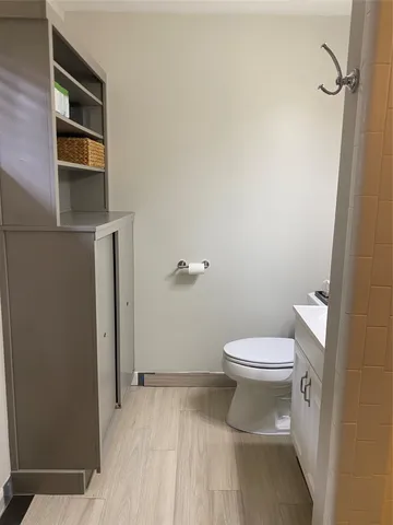 a bathroom with a toilet and a shower