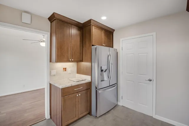 a kitchen with a refrigerator sink and cabinets