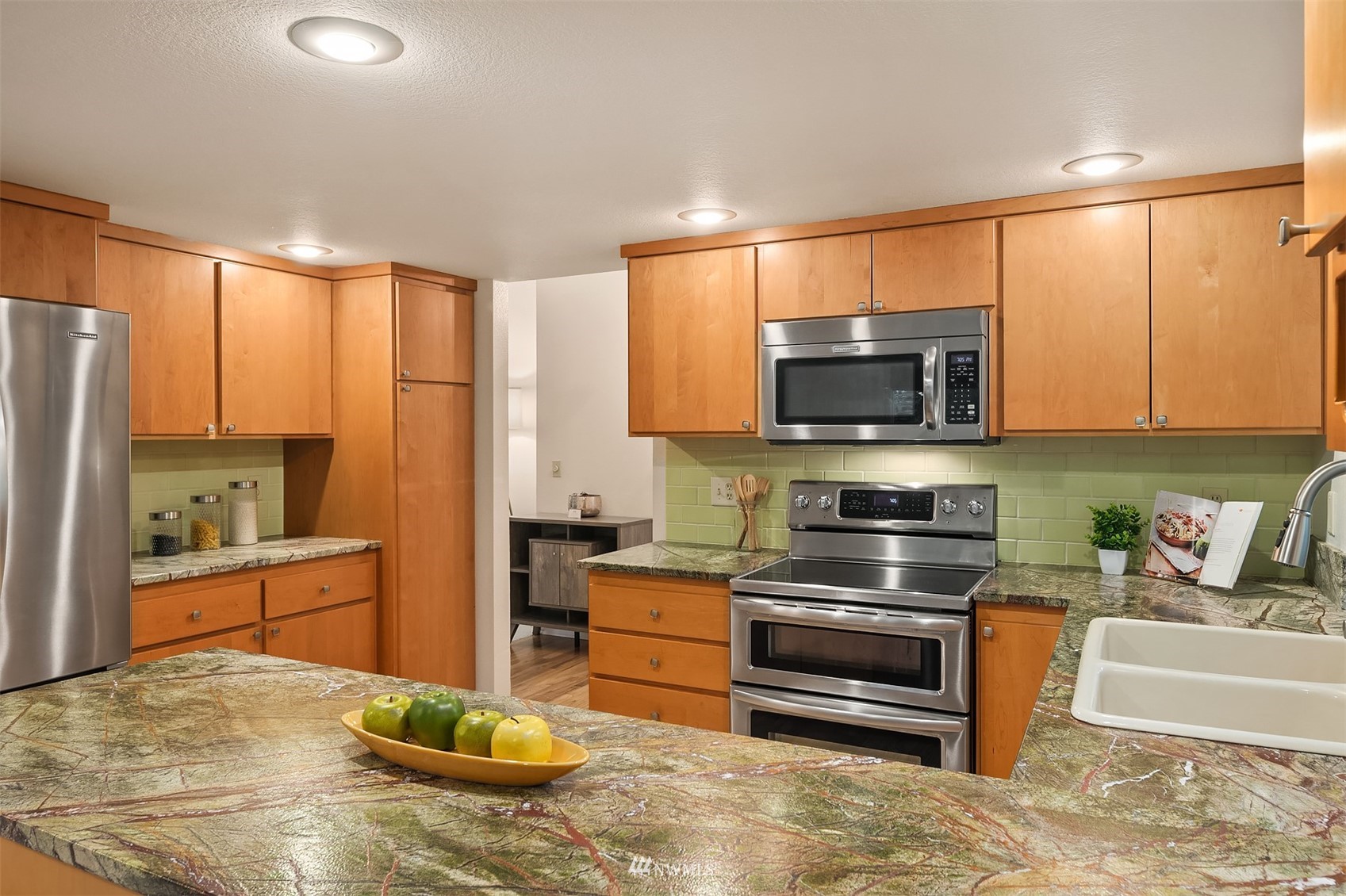 6730 114th Avenue Southeast Bellevue, WA 98006 - Photo 17 of 32 a kitchen with stainless steel appliances wooden cabinets and a stove top oven