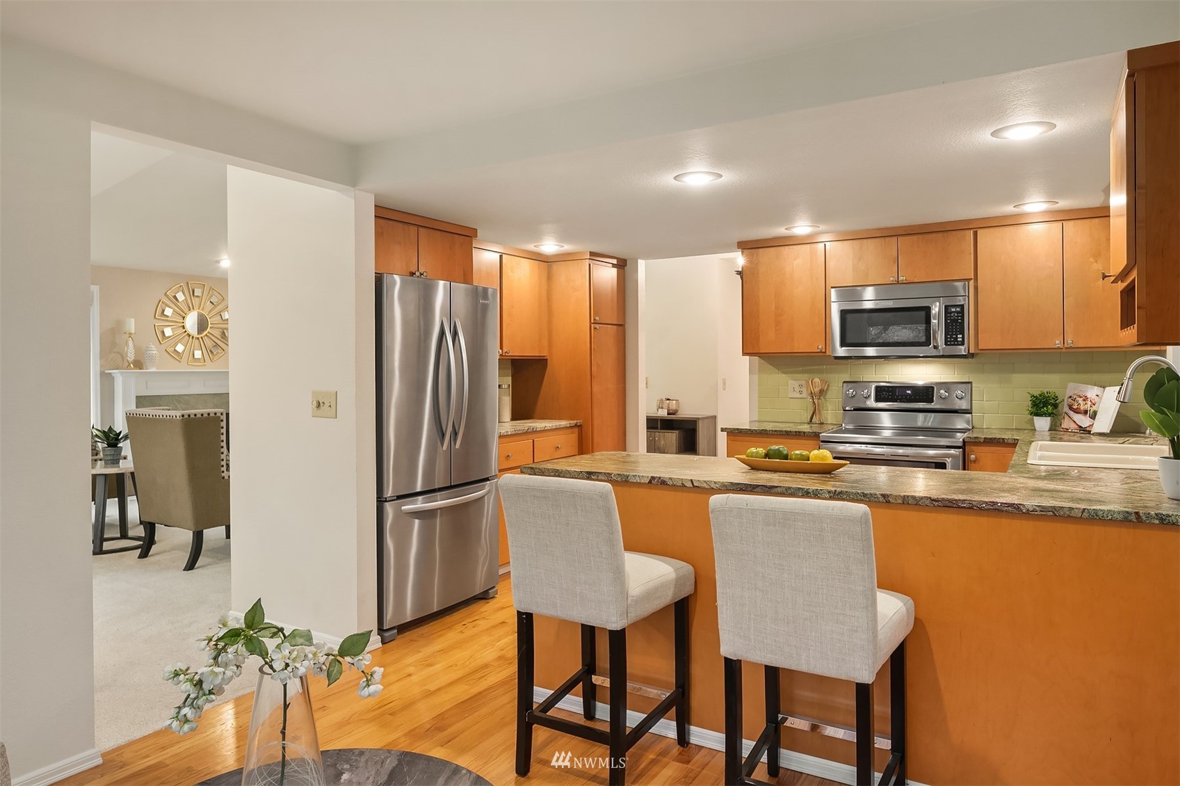 6730 114th Avenue Southeast Bellevue, WA 98006 - Photo 19 of 32 a kitchen with granite countertop a refrigerator and microwave