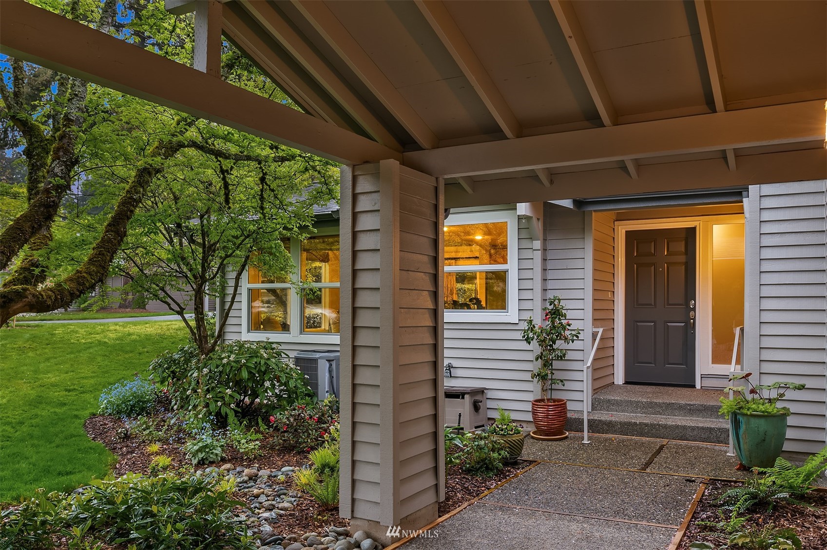 6730 114th Avenue Southeast Bellevue, WA 98006 - Photo 2 of 32 a view of a porch with plants and large trees