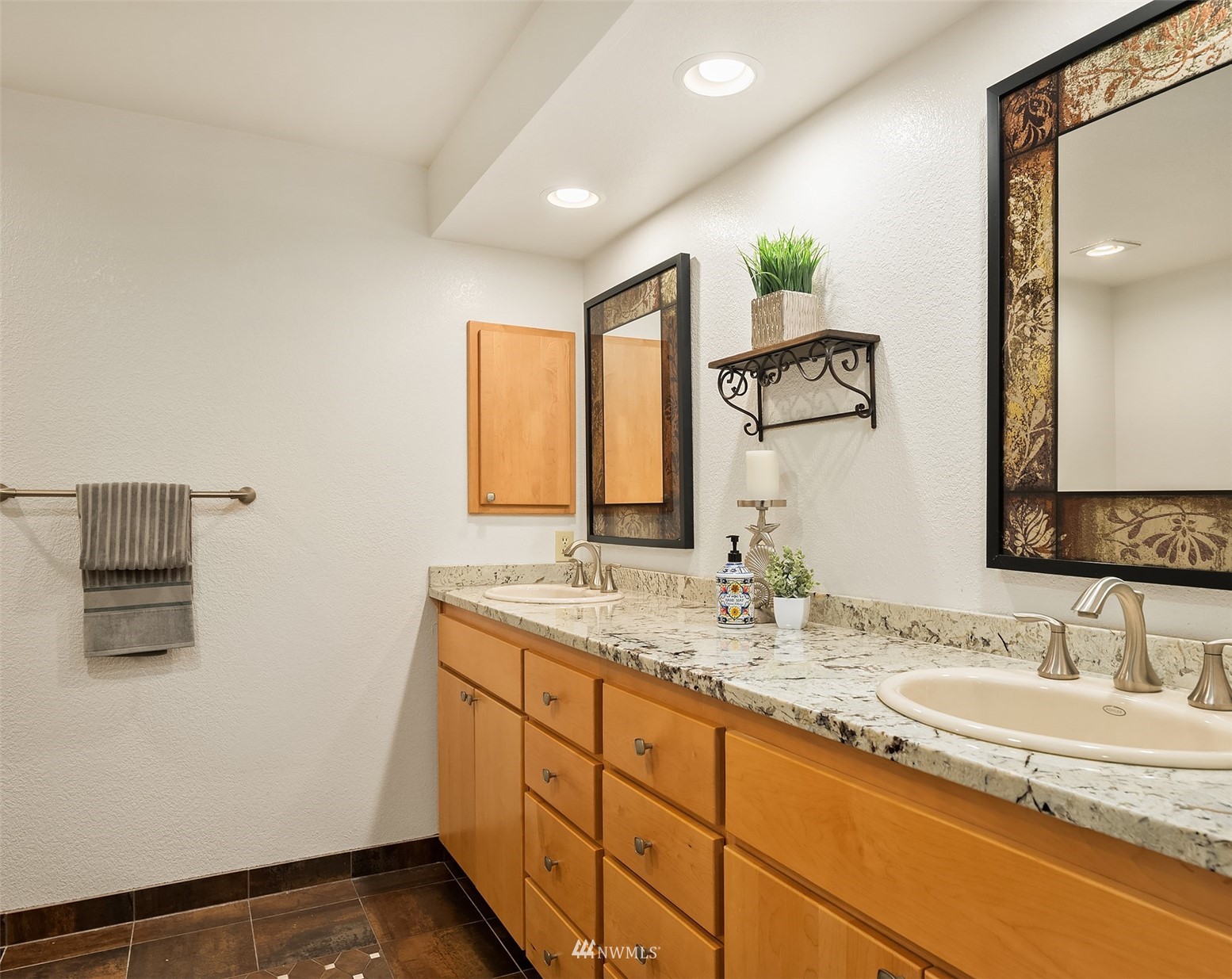 6730 114th Avenue Southeast Bellevue, WA 98006 - Photo 23 of 32 a bathroom with a granite countertop sink and a mirror