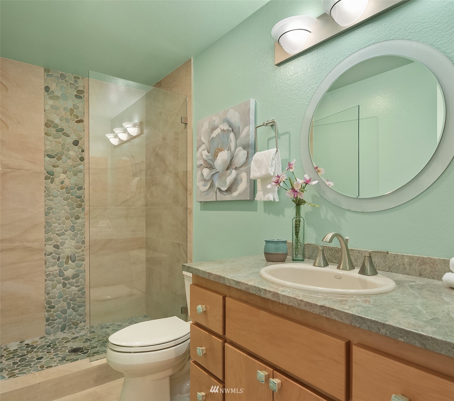6730 114th Avenue Southeast Bellevue, WA 98006 - Photo 26 of 32 a bathroom with a granite countertop toilet sink and mirror