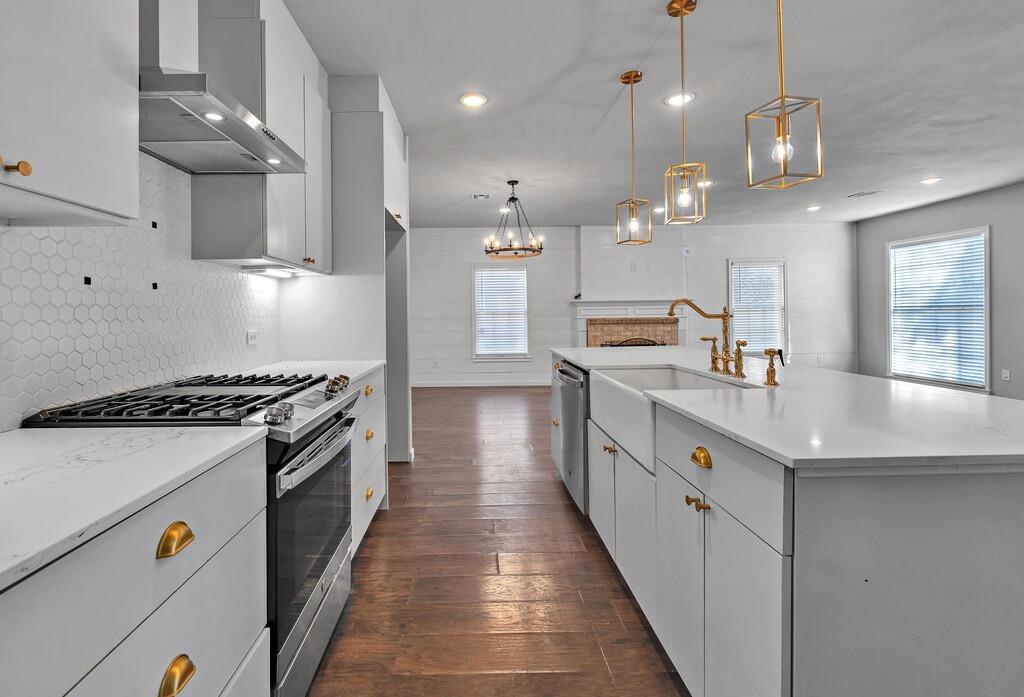 2001 Colcord Avenue Waco, TX 76707 - Photo 6 of 26 a open kitchen with stainless steel appliances granite countertop a sink a stove and a wooden floors