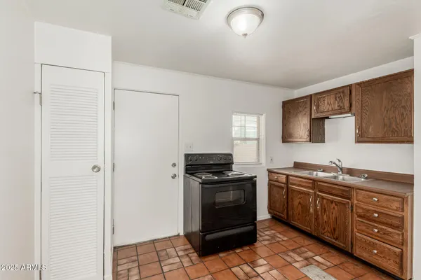 a kitchen with stainless steel appliances granite countertop a stove a sink and a refrigerator