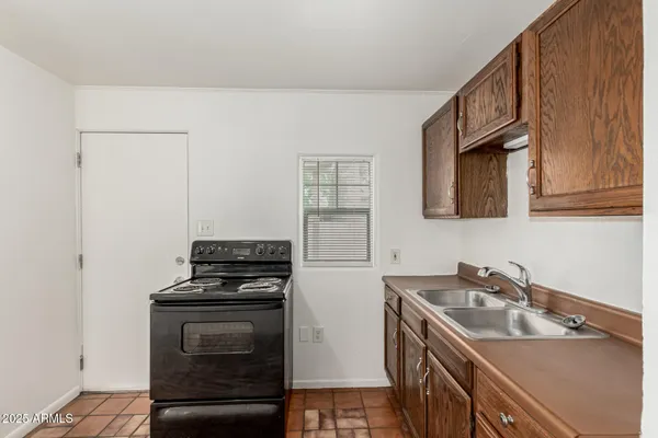 a kitchen that has a sink and a stove