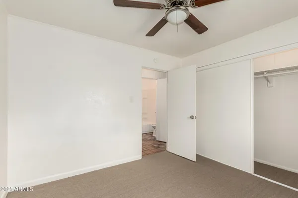 a view of a room with a ceiling fan