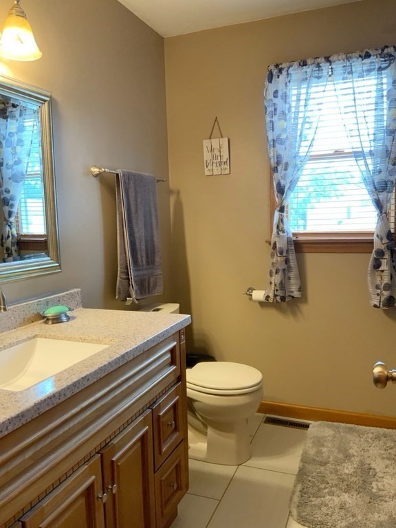 39-41 Eddy Street Springfield, MA 01104 - Photo 11 of 21 a bathroom with a granite countertop toilet sink and mirror