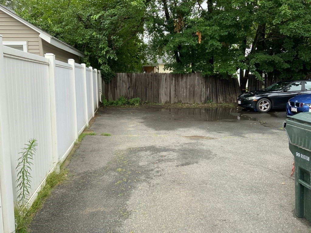 39-41 Eddy Street Springfield, MA 01104 - Photo 14 of 21 a view of a backyard with large trees and wooden fence