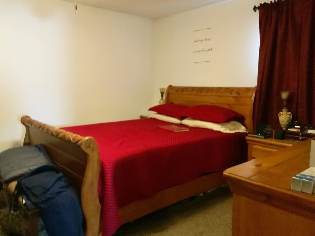 39-41 Eddy Street Springfield, MA 01104 - Photo 6 of 21 a bedroom with a bed and a night stand
