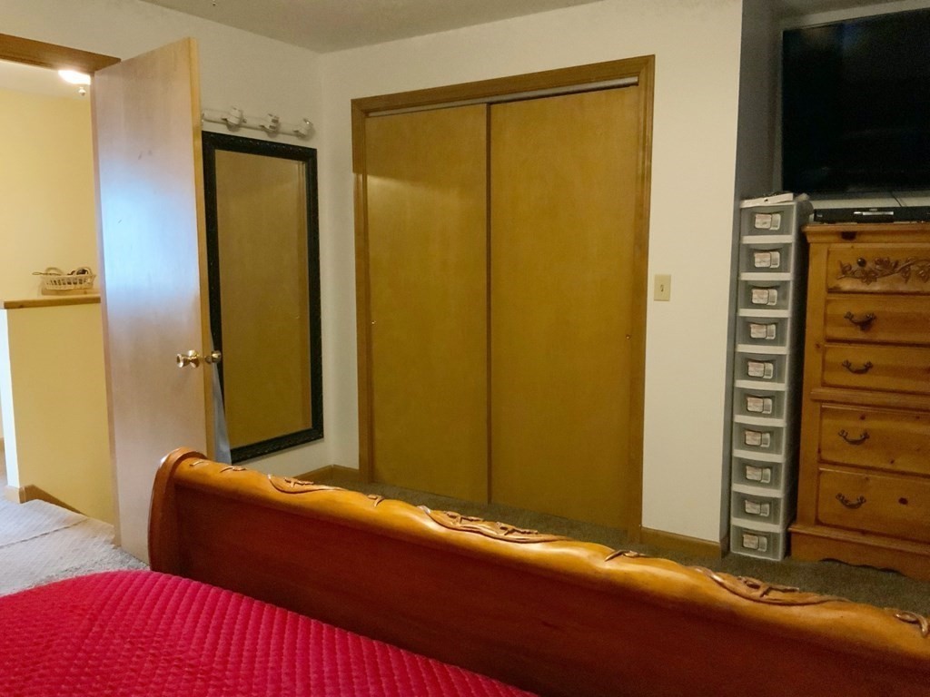 39-41 Eddy Street Springfield, MA 01104 - Photo 7 of 21 a bedroom with a bed and a flat screen tv