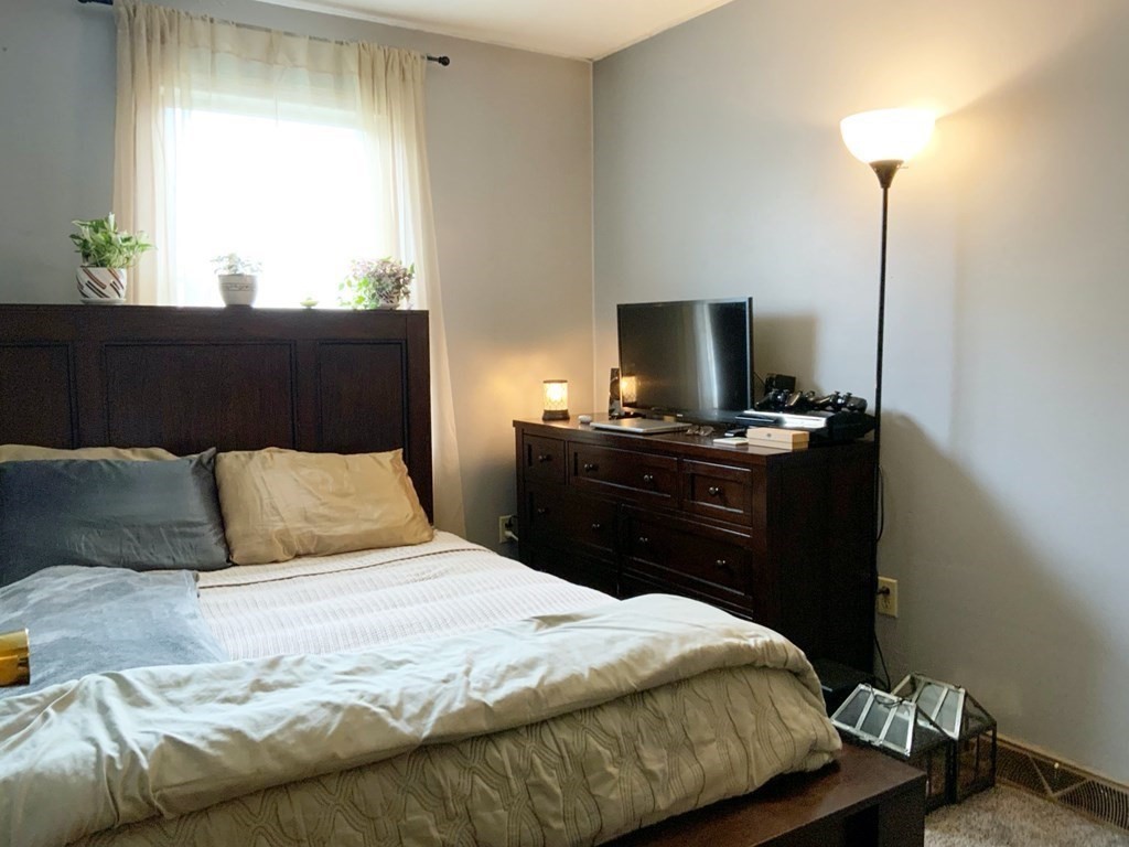 39-41 Eddy Street Springfield, MA 01104 - Photo 8 of 21 a bedroom with a bed and a window