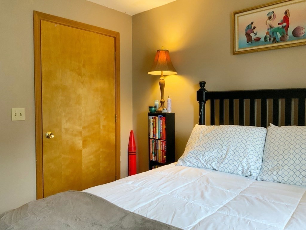 39-41 Eddy Street Springfield, MA 01104 - Photo 10 of 21 a bedroom with a bed and a painting on the wall