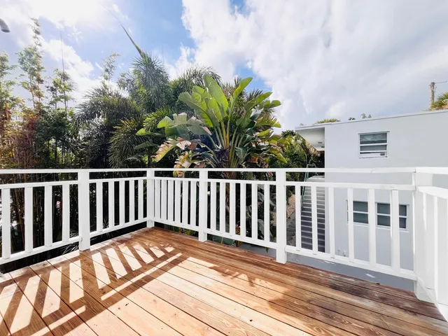 a view of a balcony with wooden floor