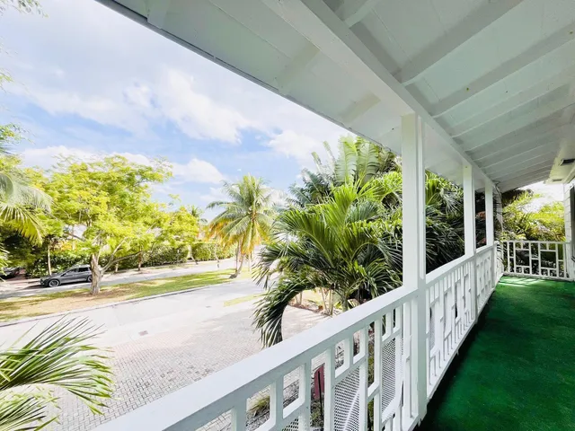 a view of a porch with wooden floor and fence