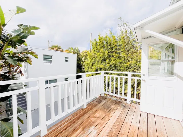 a view of a balcony with wooden floor