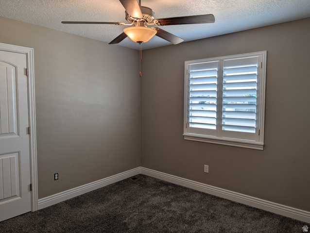 171 South Mustang Road East Grantsville, UT 84029 - Photo 10 of 41 Neutral-toned room with plush carpeting and crisp white baseboards