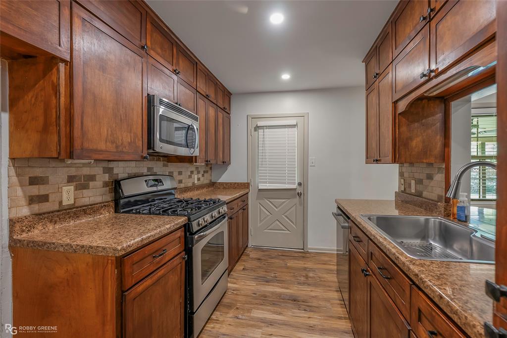 905 College Street Doyline, LA 71023 - Photo 11 of 26 a kitchen with a stove sink and cabinets