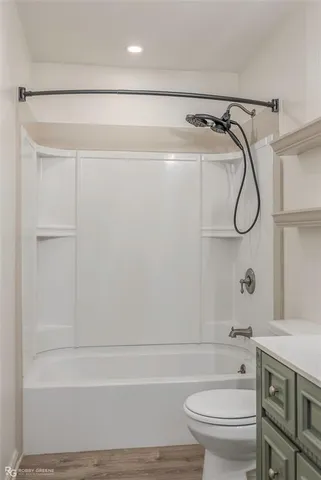 a bathroom with a shower a toilet and sink