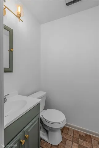 a white toilet sitting next to a white sink