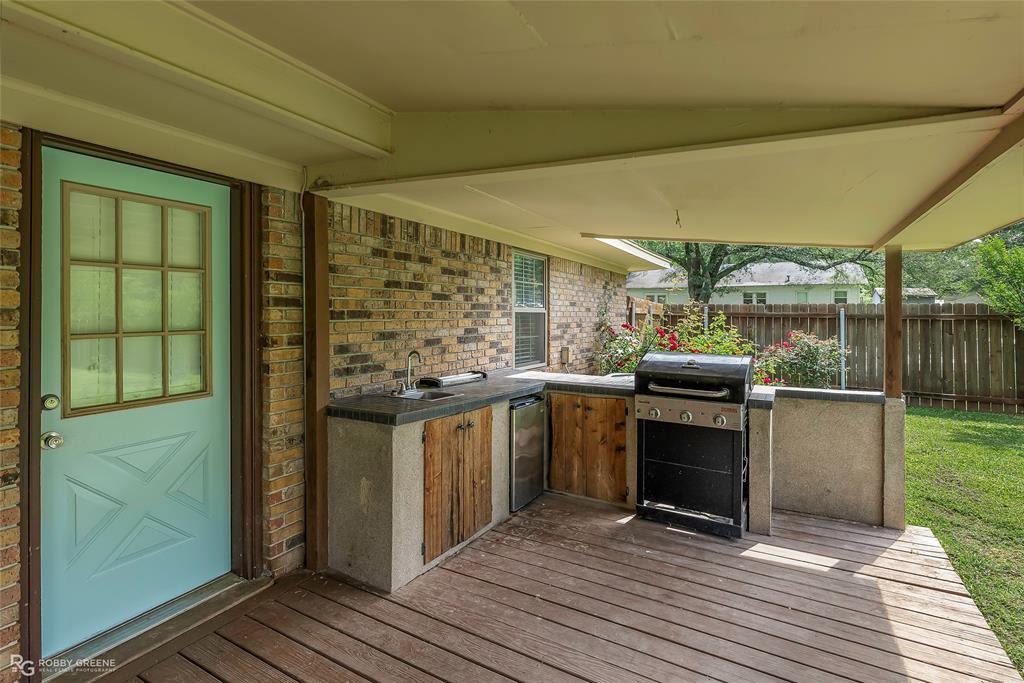 905 College Street Doyline, LA 71023 - Photo 25 of 26 a kitchen with stainless steel appliances granite countertop a stove a sink and a microwave