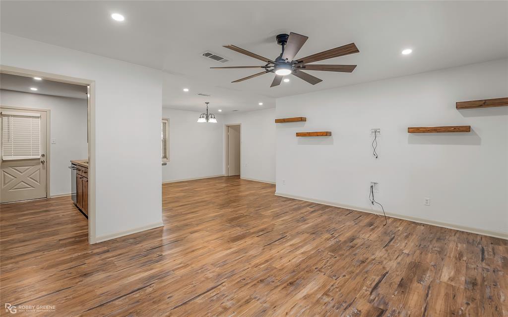 905 College Street Doyline, LA 71023 - Photo 6 of 26 a view of a livingroom with wooden floor and a ceiling fan