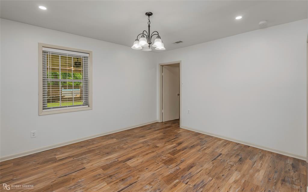 905 College Street Doyline, LA 71023 - Photo 7 of 26 a view of an empty room with wooden floor and a window