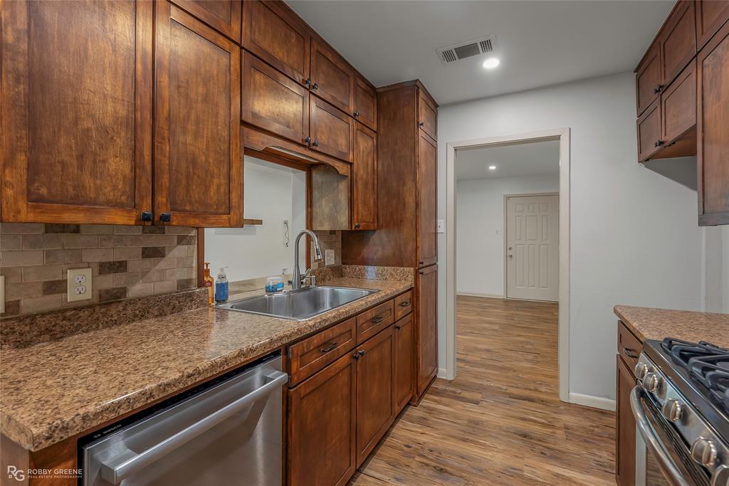 905 College Street Doyline, LA 71023 - Photo 10 of 26 a kitchen with granite countertop a sink stove and cabinets