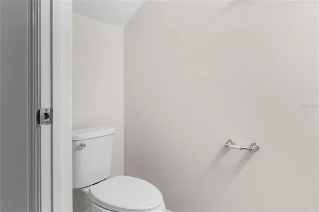a white toilet sitting next to a shower