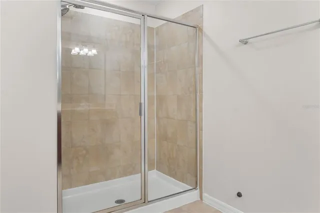 a bathroom with a glass shower door