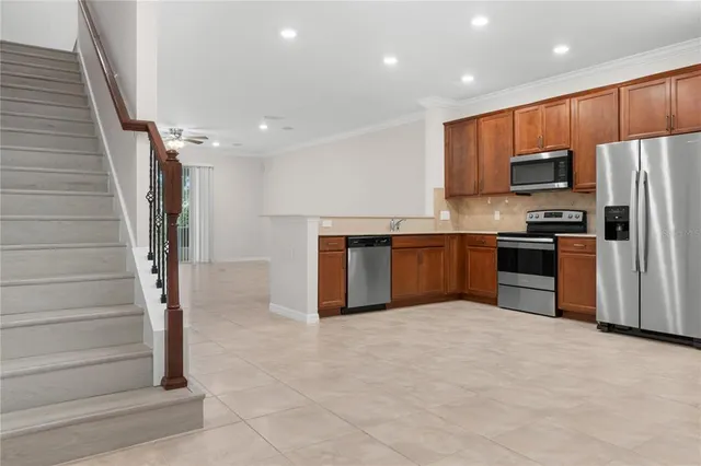 a kitchen with stainless steel appliances granite countertop a stove top oven a sink and dishwasher